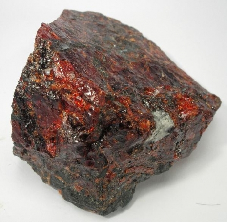 "Calderite Garnet: Deep red gemstone symbolizing vitality and passion."