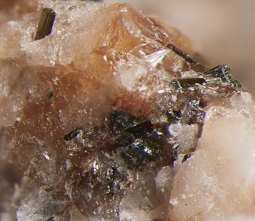 Shiny Manganotychite mineral specimen on dark background.