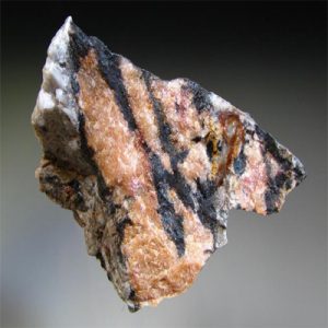 Lithiophilite mineral specimen, a gemstone with pink hues.