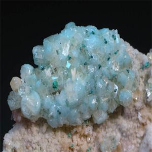 Glowing green willemite mineral under UV light