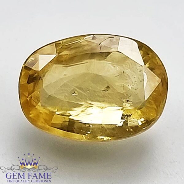A vibrant yellow sapphire gemstone, glowing with a bright golden hue